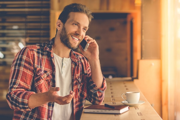 Handsome designer is talking on the mobile phone