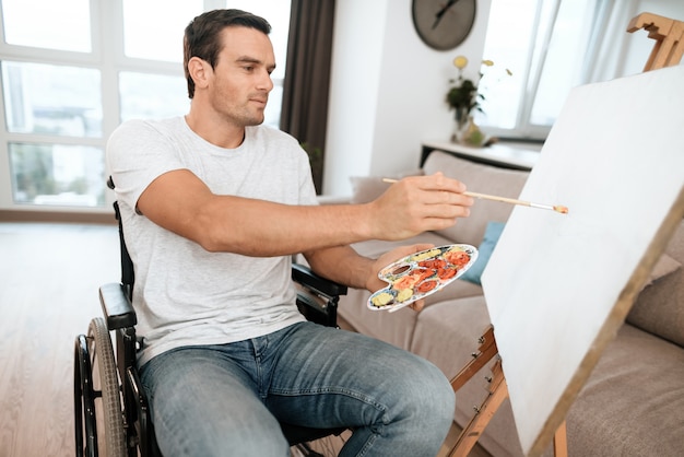 Handsome Disabled Young Man Painting Picture.