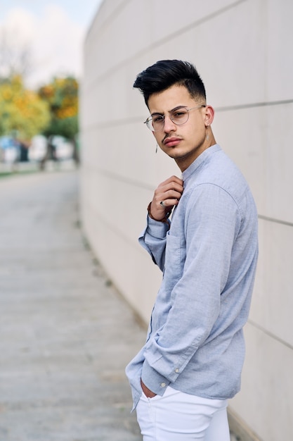 Handsome and elegant young man posing and looking straight