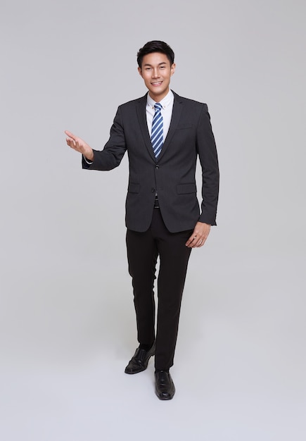 Handsome and friendly face asian businessman smile in formal suit on white background studio shot.