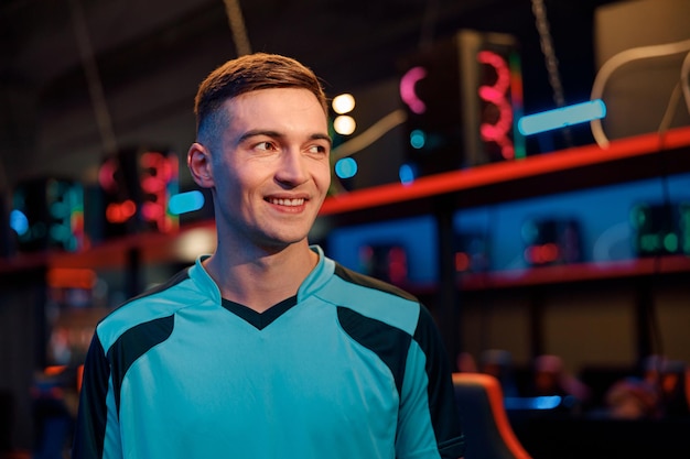 Handsome gamer satisfied with game in computer club