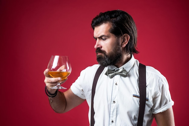 Handsome guy hipster with moustache and beard drink kignac barkeeper