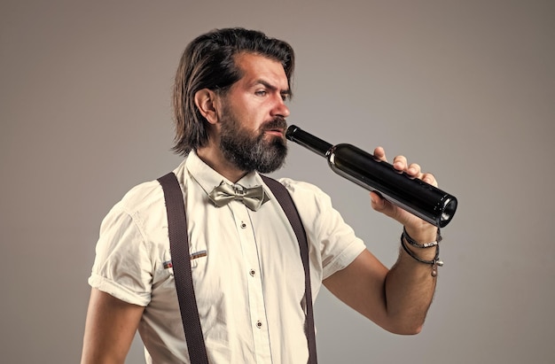 Handsome guy hipster with moustache and beard drinking wine drinking beverage