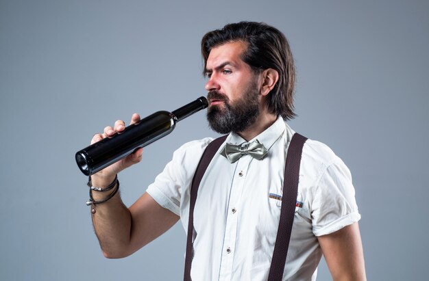 Handsome guy hipster with moustache and beard drinking wine drinking beverage