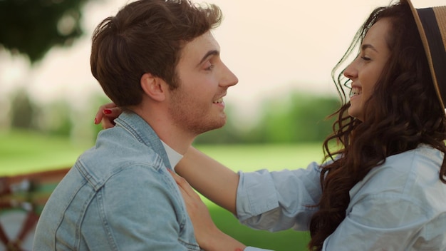 Handsome guy making laugh girl outdoors Loving couple laughing on picnic