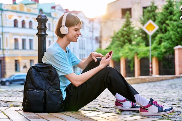 Handsome guy making video call on smartphone outdoor