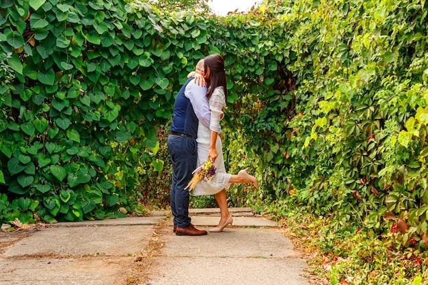 Handsome guy with flowers kisses his fiancee