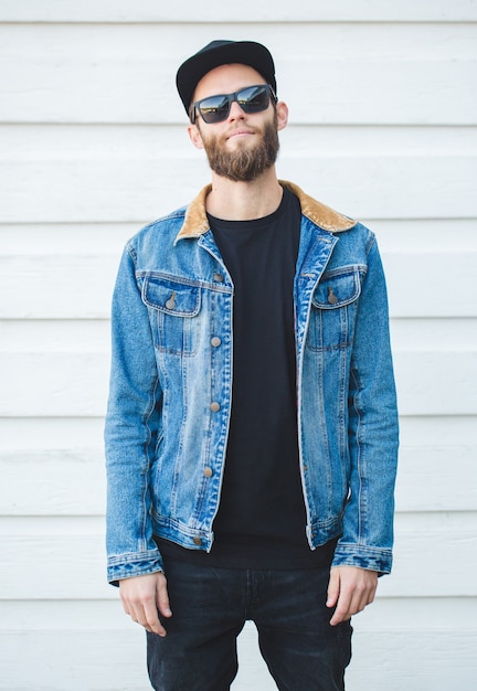 Handsome hipster man smiling wearing trendy jeans clothes