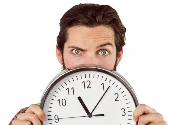 Handsome hipster showing a clock