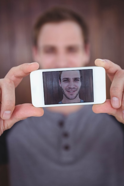 Handsome hipster taking selfie