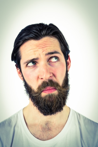 Handsome hipster thinking and looking up