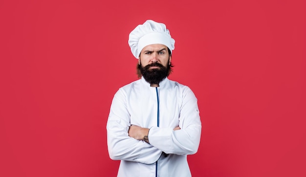 Handsome hipster with beard and moustache crossed hands culinary