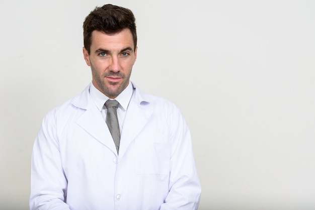 handsome Hispanic man doctor on white