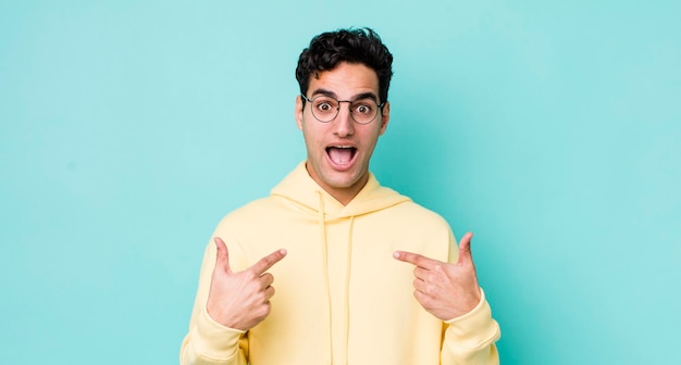 Handsome hispanic man feeling happy surprised and proud pointing to self with an excited amazed look