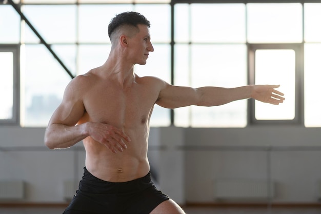 Handsome hispanic man training in gym doing exercises yoga exercises Concept of yoga