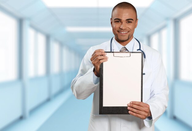 Handsome male Doctor holding clipboard