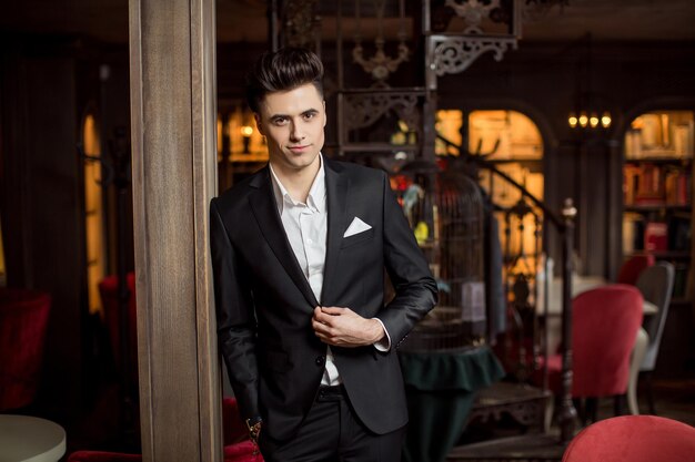 Handsome male model in a new suit in a beautiful room