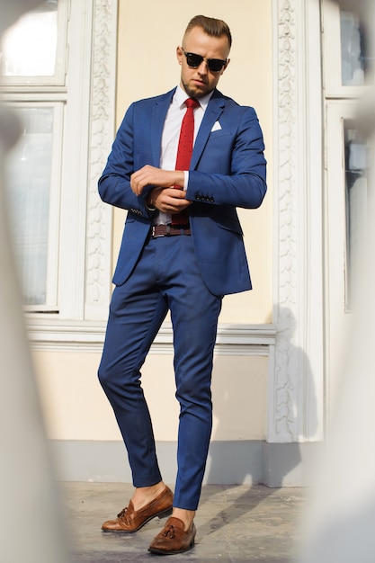 Handsome male model posing wearing a blue suit.