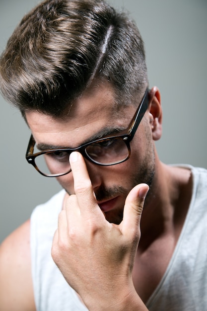 Handsome man adjusting his glasses