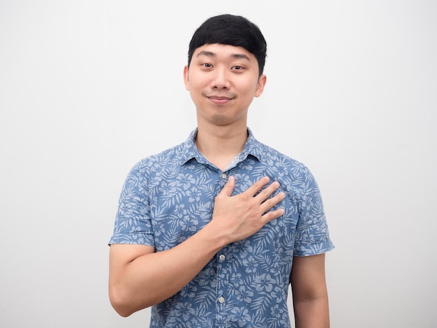 Handsome man blue shirt cheerful and touch his chest feeling hopeful