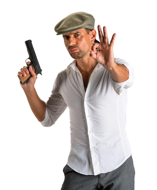 Handsome man in cap with a gun