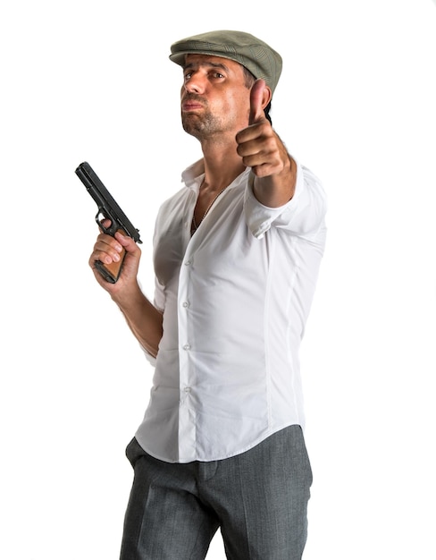 Handsome man in cap with a gun