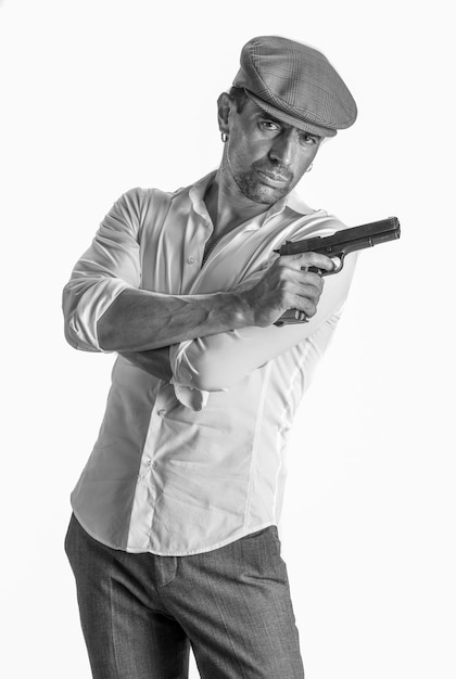 Handsome man in cap with a gun