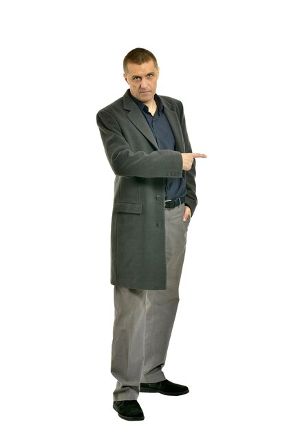 Handsome Man in coat pointing up on a white background