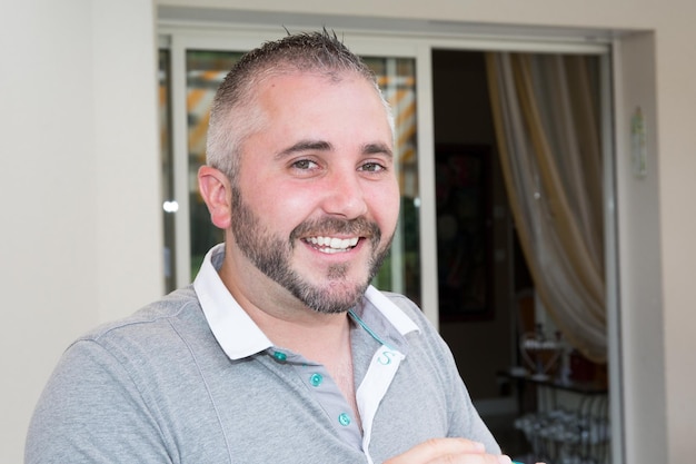 Handsome man front of home house summer