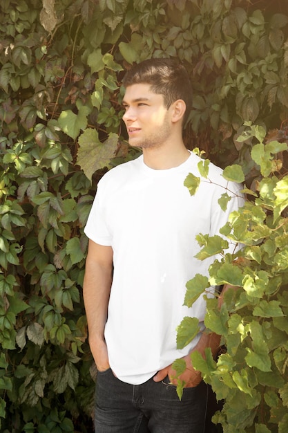 Handsome man on green leaves background