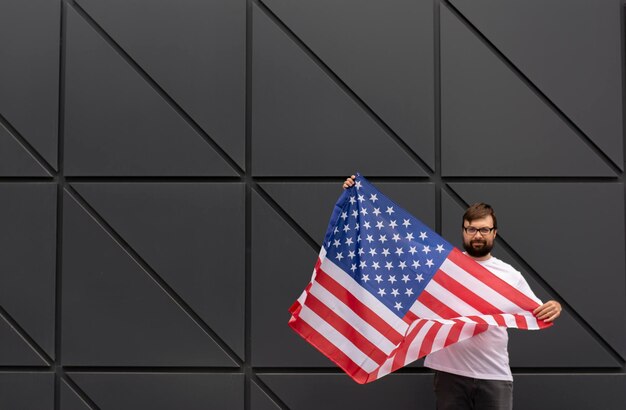 Handsome man holding an american flag 4th July American Independence Day is a patriotic holiday