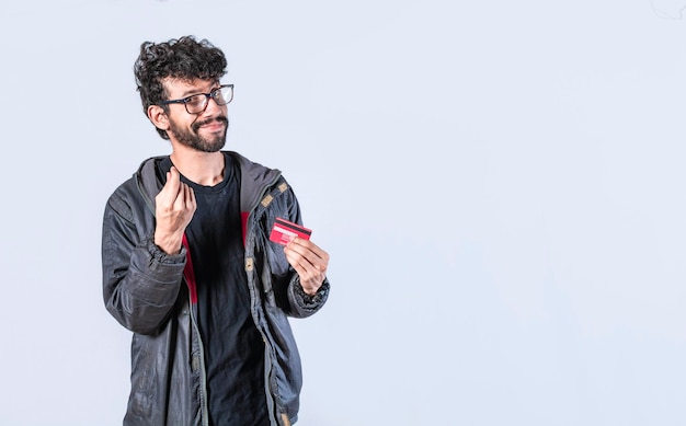 Handsome man holding credit card guy in glasses holding credit card smiling electronic payment concept