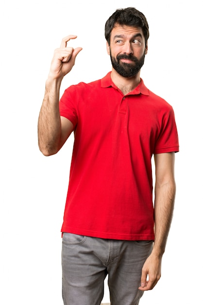 Handsome man making tiny sign