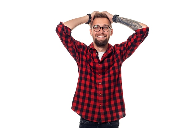 Handsome man model studio portrait. Boy casual style, trendy hipster in checkered shirt look with cool hairstyle. Studio shot on white background. Copy space