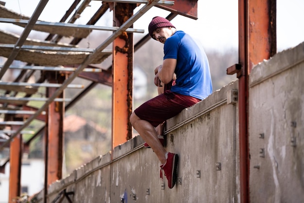 Handsome Man Resting After Exercises on Concrete Block