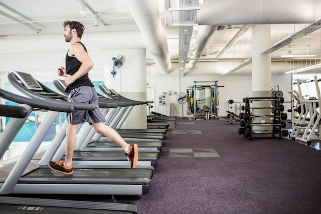 Handsome man running on treadmill