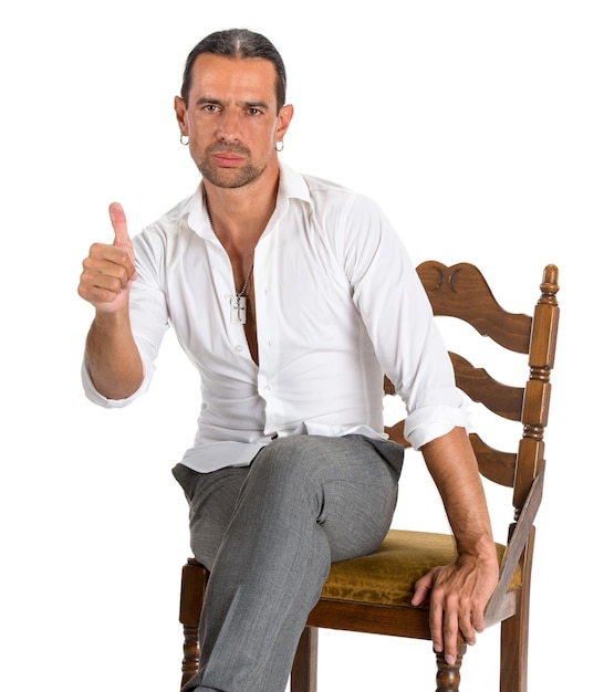 Handsome man sitting on a chair and showing ok sign