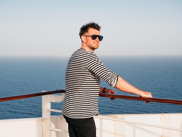 Handsome man standing on the empty deck