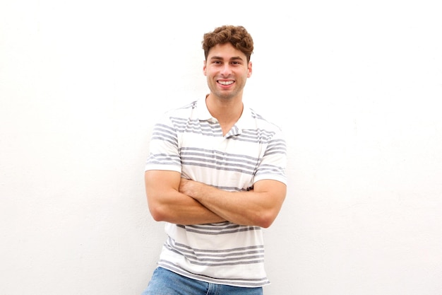 Handsome man standing and smiling with arms crossed