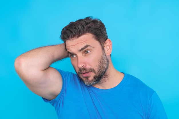 Handsome man standing over yellow background with hand on chin thinking about question pensive expre