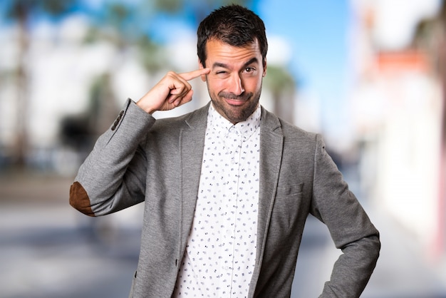 Handsome man thinking on unfocused background