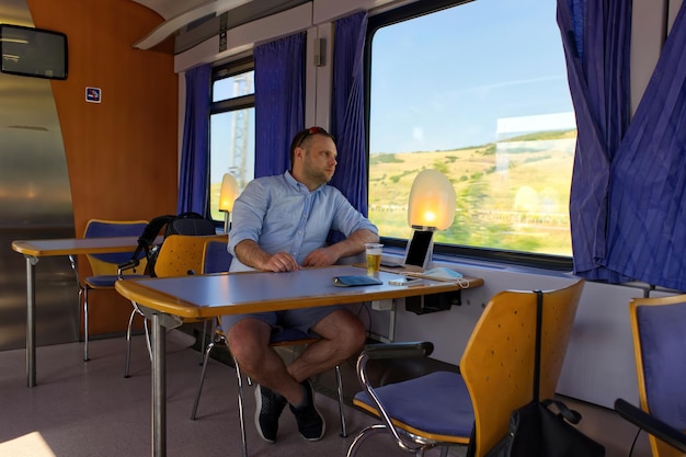 Handsome Man traveling by Train And Looking Out The Window Stock Photo