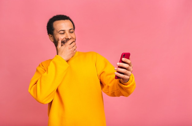 Handsome man using mobile phone and drinking take away coffee cup