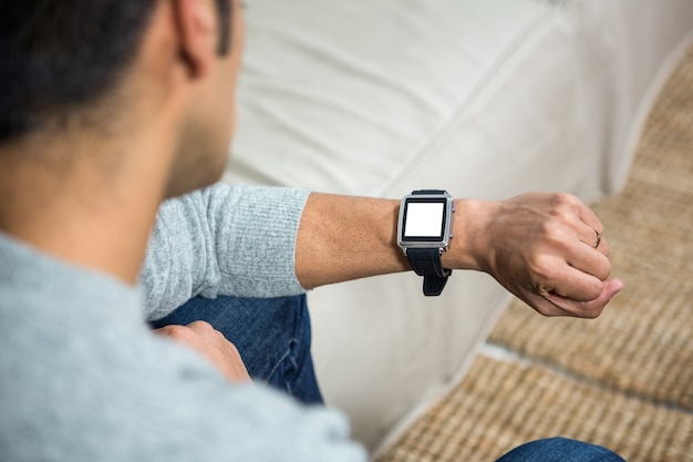 Handsome man using smartwatch