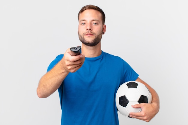 Handsome man watching soccer at television