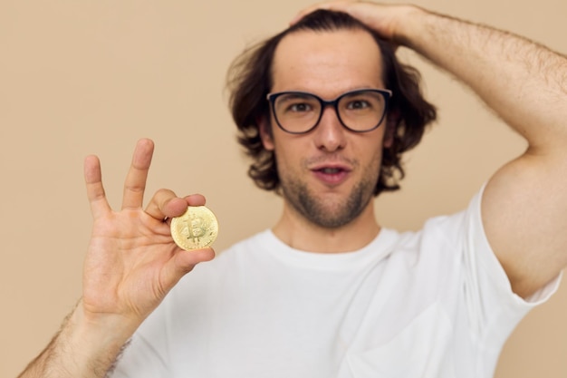 Handsome man in a white tshirt with bitcoin cryptocurrency isolated background