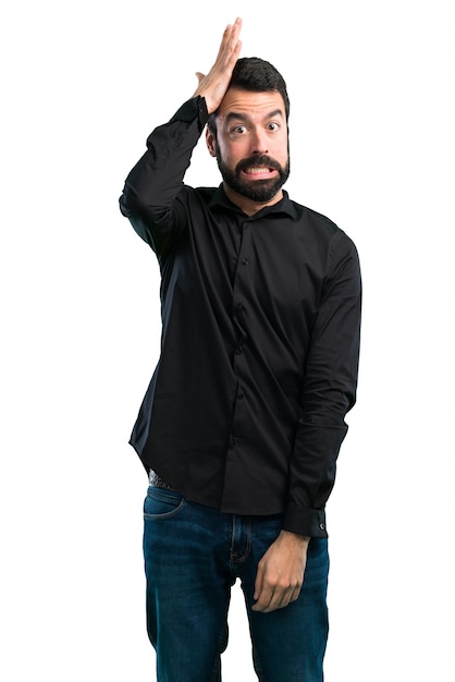 Handsome man with beard having doubts on white background