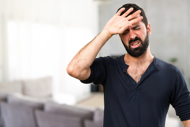 Handsome man with beard with fever inside house