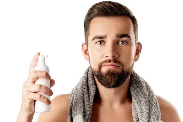 Handsome man with a cleansing or shaving foam on white background