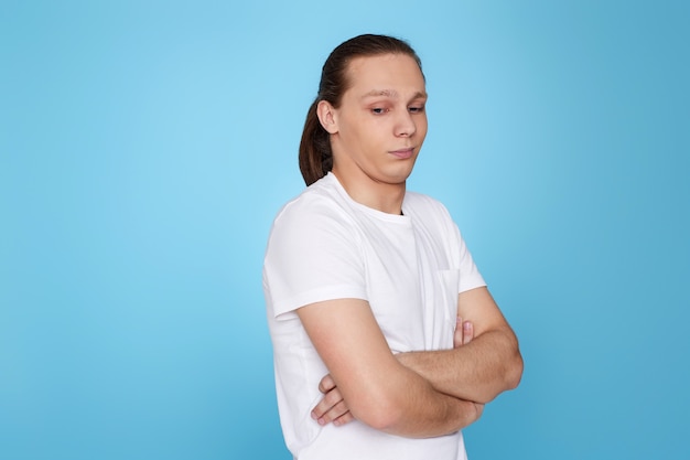 Handsome man with a doubt on his face in t-shirt